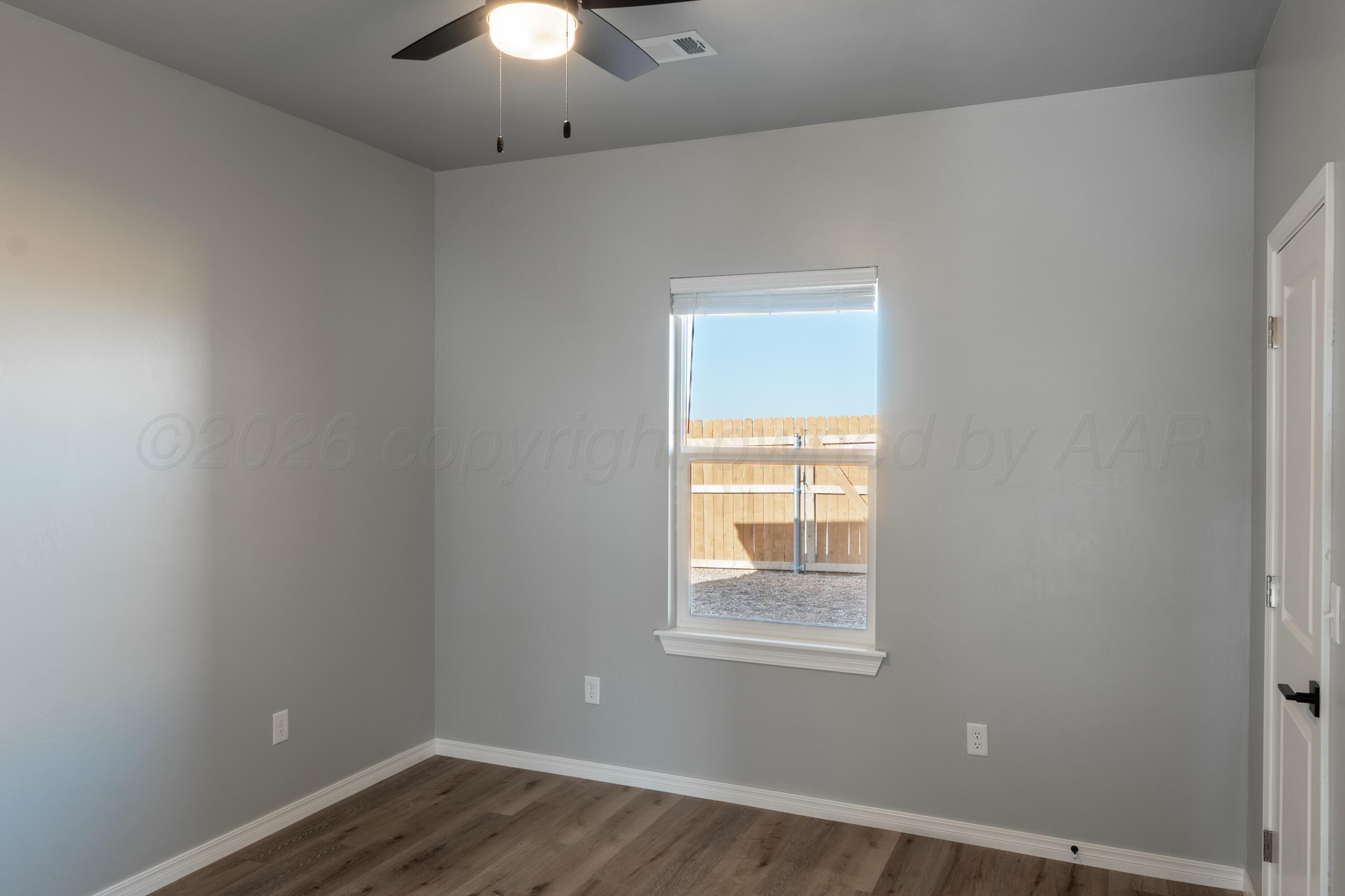 11074 Verano Drive Amarillo, TX 79119 - Photo 13 of 15 an empty room with a window