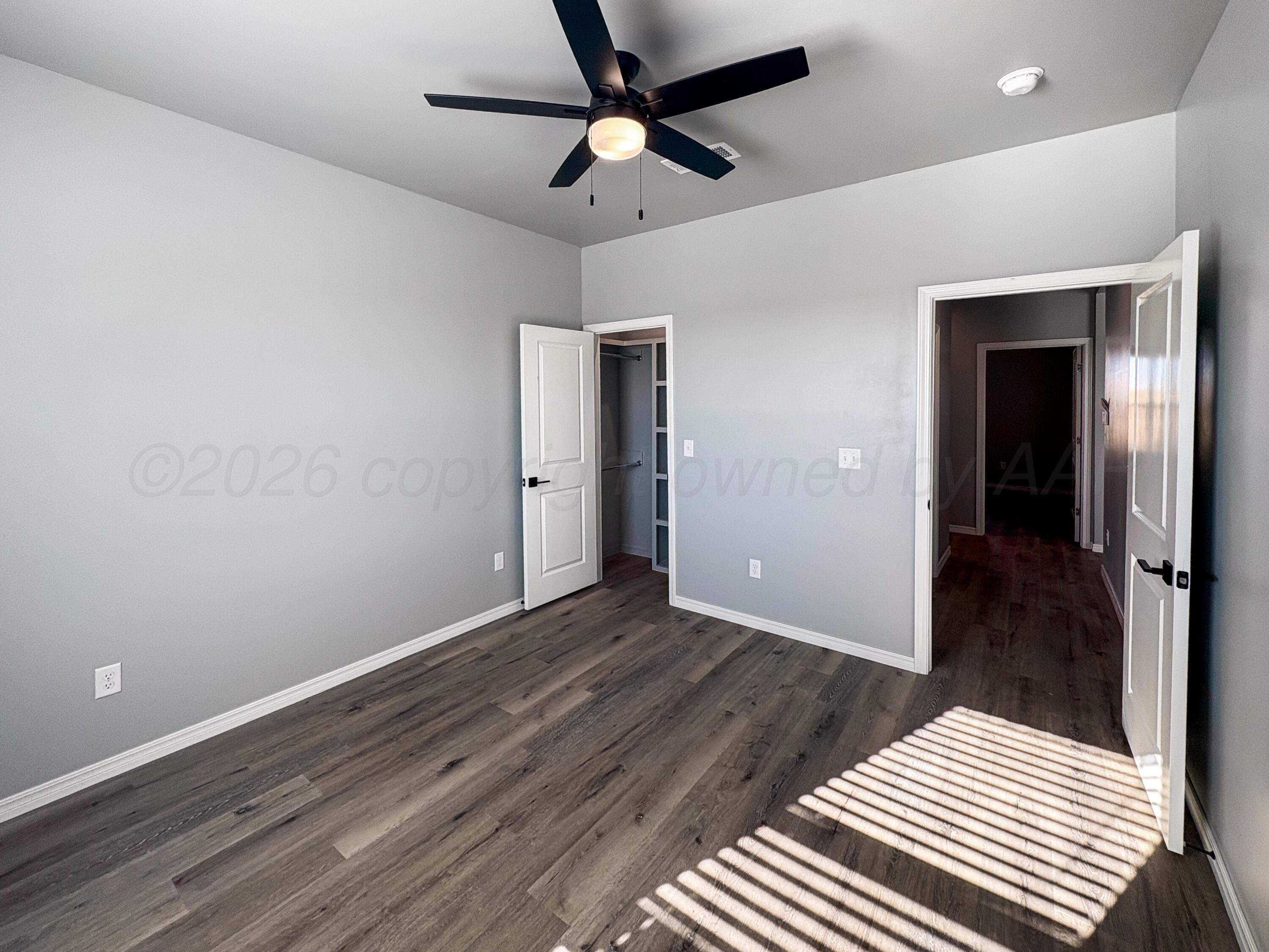 11074 Verano Drive Amarillo, TX 79119 - Photo 10 of 15 a view of a room with wooden floor and ceiling fan