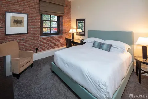 a spacious bedroom with a bed and a couch