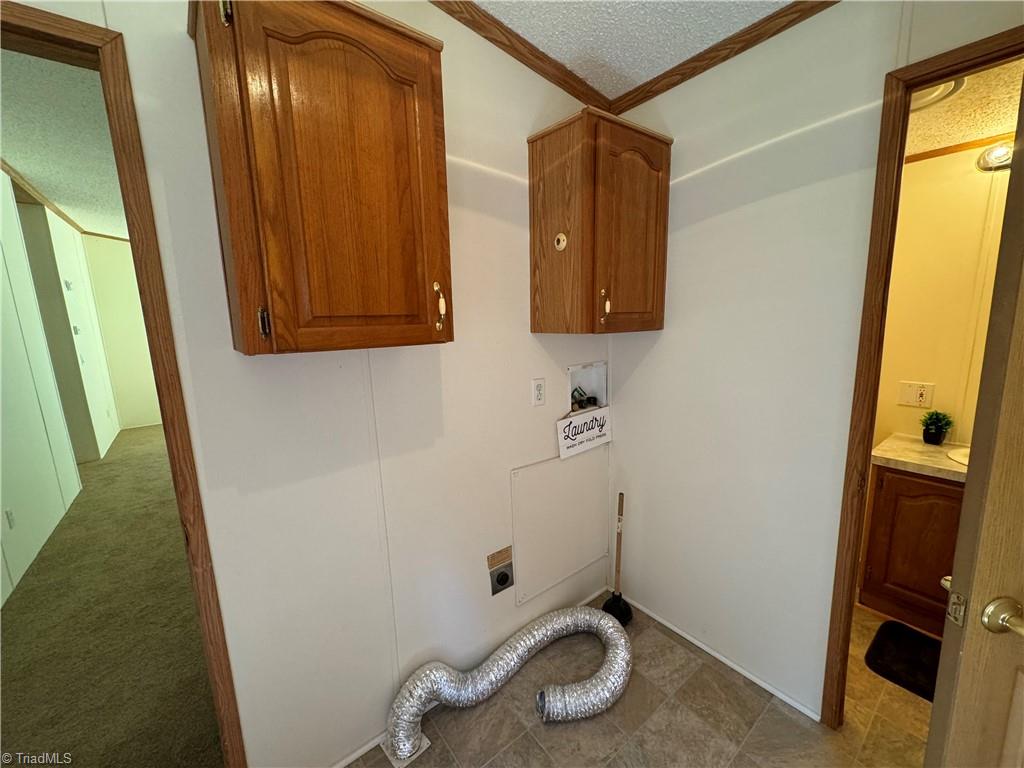 178 Waddell Street Ronda, NC 28670 - Photo 23 of 47 Laundry room behind the fireplace with an exit to the side porch