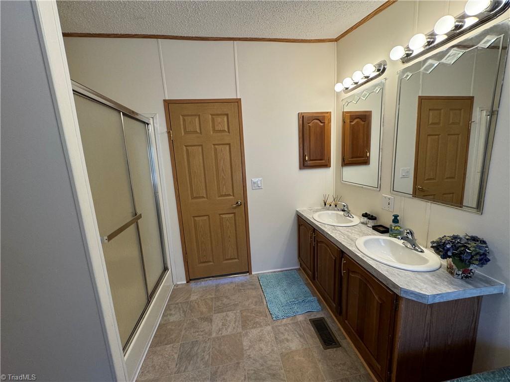178 Waddell Street Ronda, NC 28670 - Photo 38 of 47 Primary bath has new countertops, double sinks, and double walk in shower