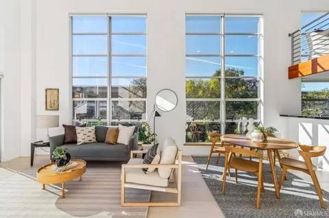 a living room with furniture a rug and a large window