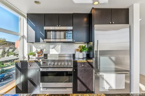 a kitchen with a stove and a refrigerator