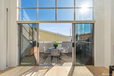 a balcony with table and chairs