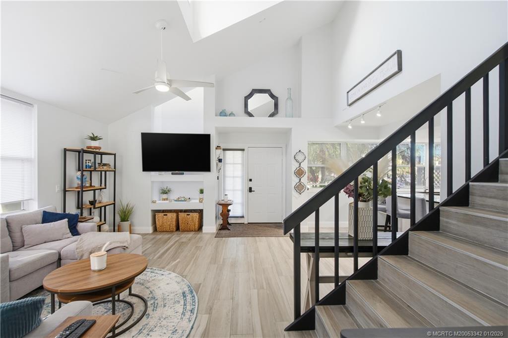 3584 Southwest Sunset Trace Circle Palm City, FL 34990 - Photo 12 of 32 a living room with furniture and a flat screen tv