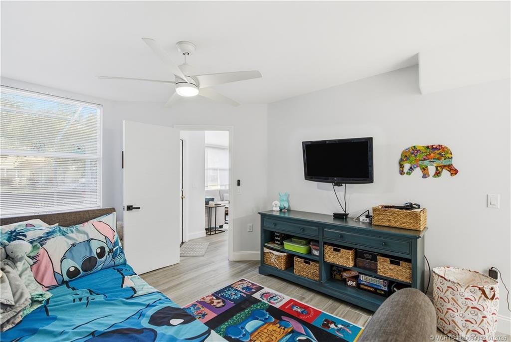 3584 Southwest Sunset Trace Circle Palm City, FL 34990 - Photo 13 of 32 a living room with furniture and a flat screen tv