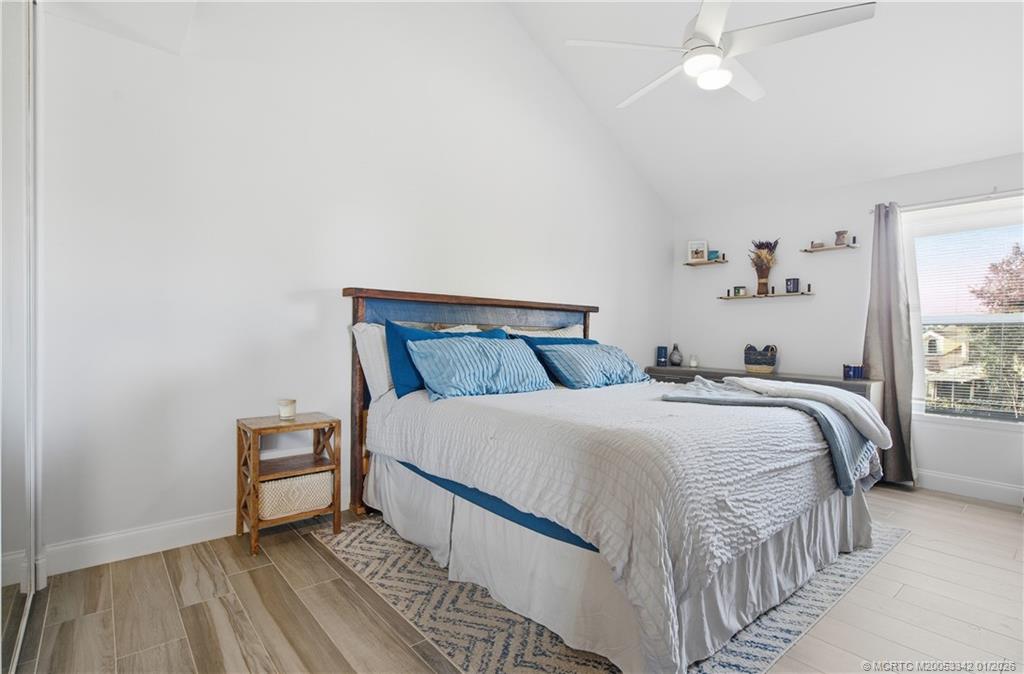 3584 Southwest Sunset Trace Circle Palm City, FL 34990 - Photo 19 of 32 a bedroom with a bed and a window