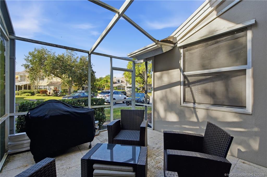 3584 Southwest Sunset Trace Circle Palm City, FL 34990 - Photo 22 of 32 a living room with a couch and a table
