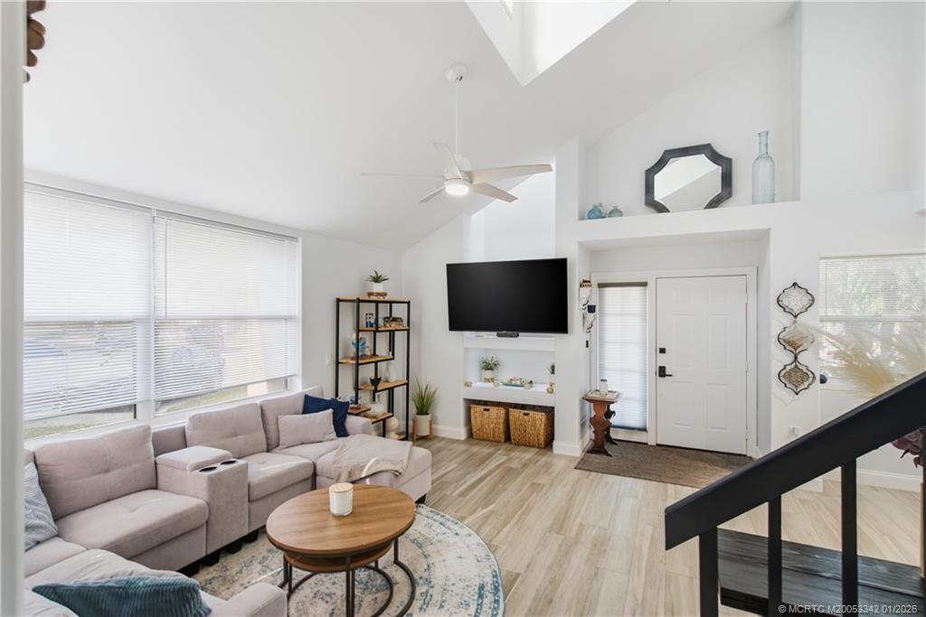 3584 Southwest Sunset Trace Circle Palm City, FL 34990 - Photo 3 of 32 a living room with furniture a flat screen tv and a large window