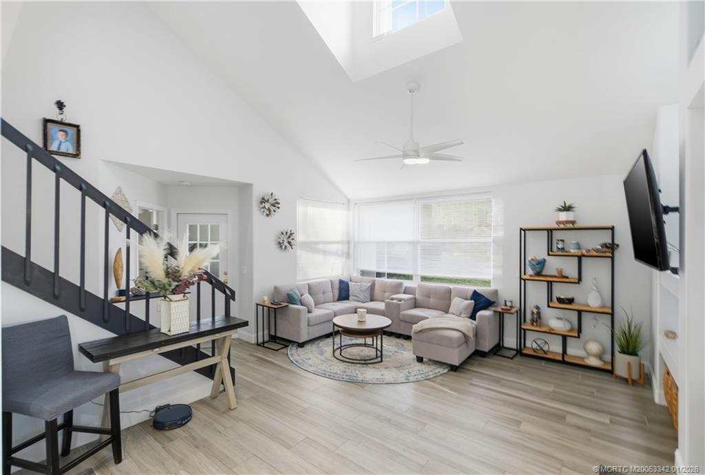 3584 Southwest Sunset Trace Circle Palm City, FL 34990 - Photo 4 of 32 a living room with furniture and a flat screen tv