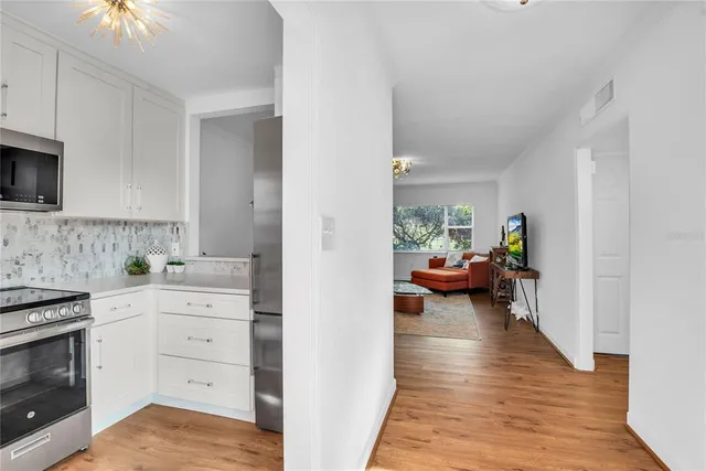 a view of a kitchen and a stove top oven