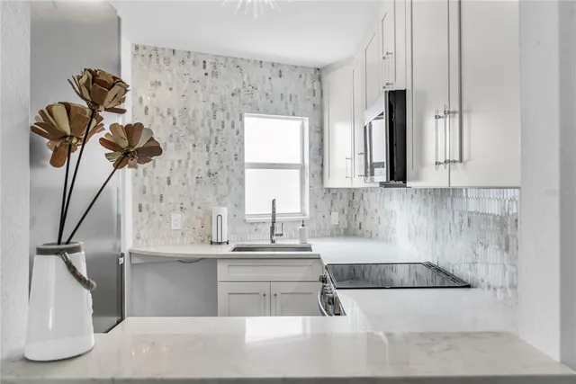 a kitchen with a sink a cabinets and window