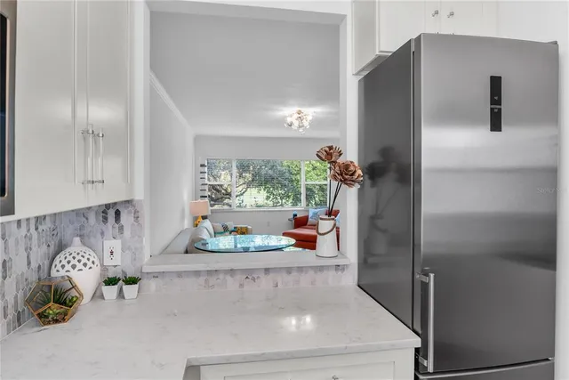 a kitchen with a refrigerator and a window