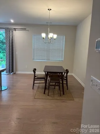a view of a dining room with furniture and window