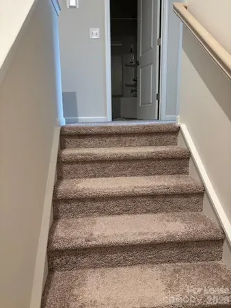 a view of staircase with white walls