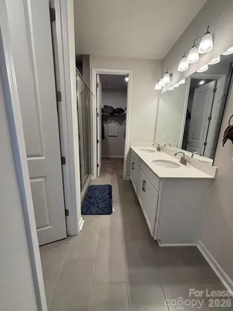 a bathroom with a double vanity sink and a mirror