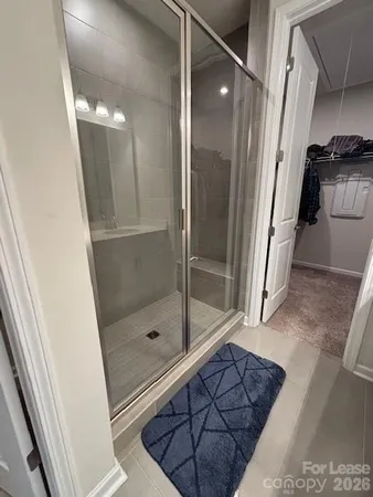a bathroom with a glass door shower and a sink