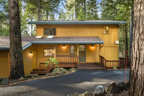 a view of a house with a wooden fence
