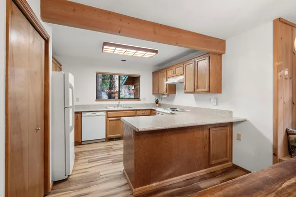 a kitchen with a sink stove and cabinets