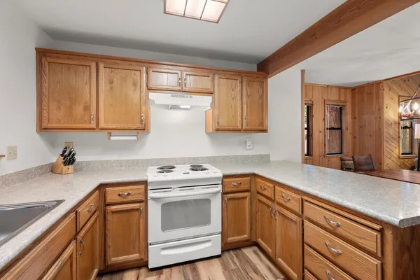 a kitchen with a sink stove and cabinets