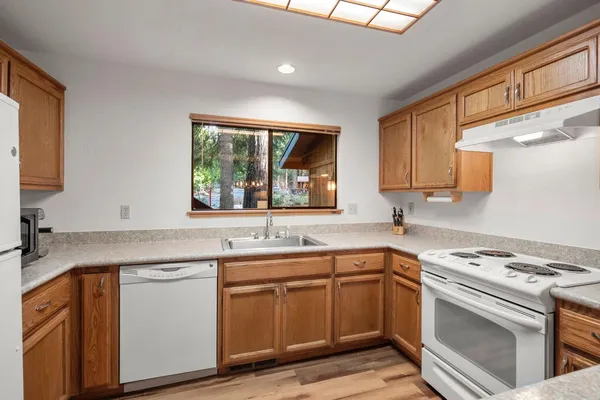 a kitchen with a refrigerator sink stove and cabinets