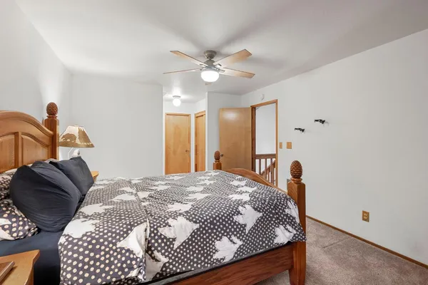 a bedroom with a bed and a chandelier