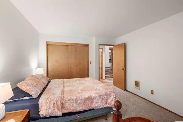 a bedroom with two beds and painting on the wall