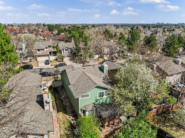 an aerial view of a city with lots of residential buildings ocean and mountain view in back
