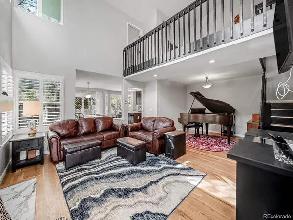 a living room with furniture a wooden floor and a window