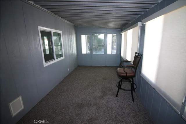 a view of room with window and furniture