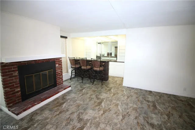 a living room with furniture a window and a fireplace