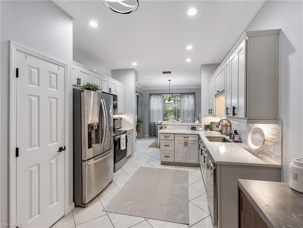 20334 Larino Loop Estero, FL 33928 - Photo 12 of 39 a kitchen with a sink appliances and cabinets