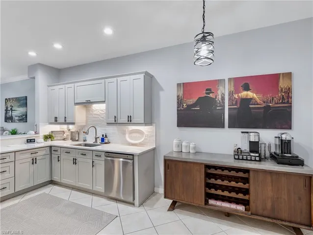a kitchen with stainless steel appliances a stove a sink and cabinets