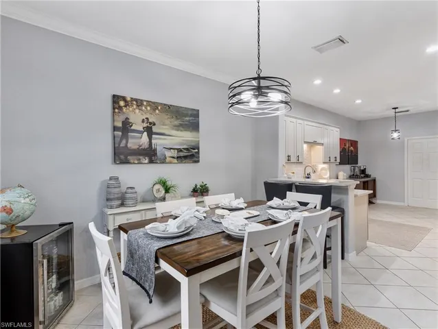 a view of a dining room with furniture wooden floor and chandelier