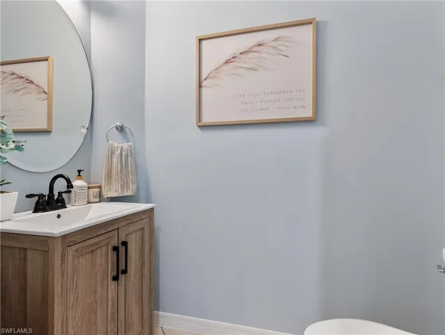 a bathroom with a sink a toilet and mirror