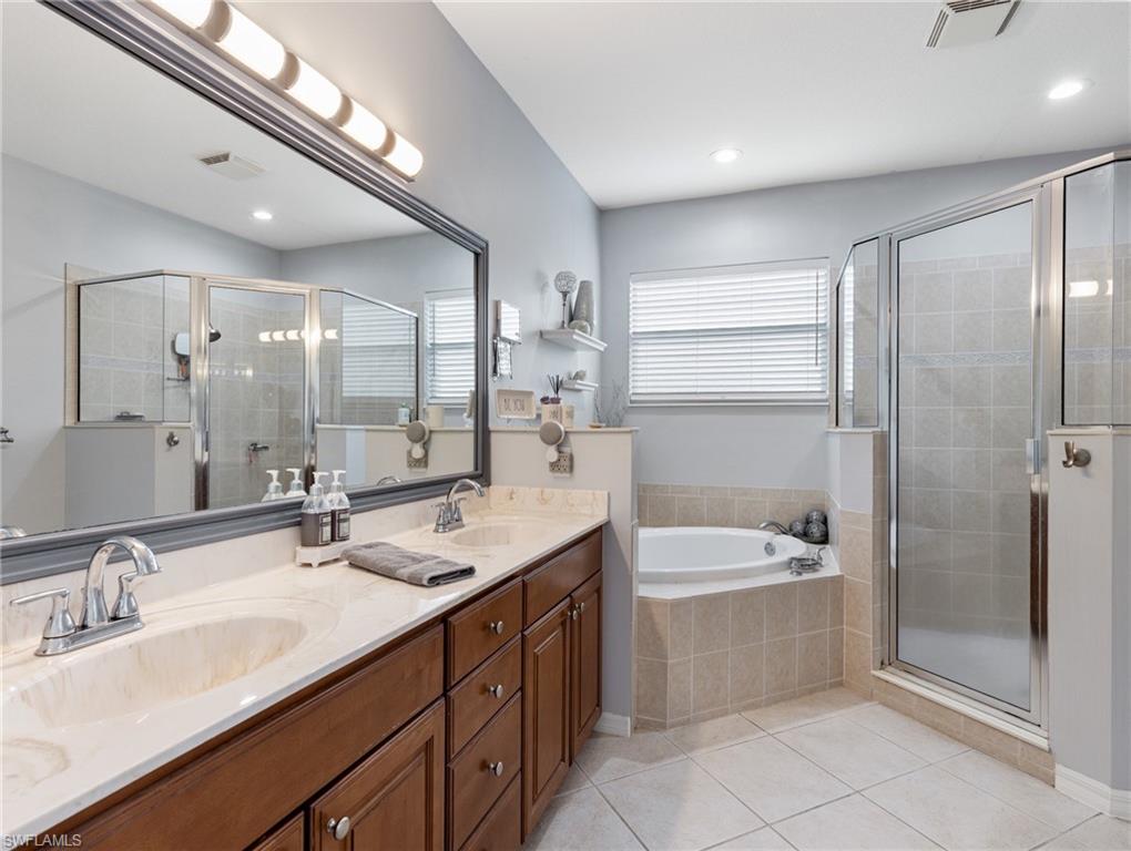 20334 Larino Loop Estero, FL 33928 - Photo 28 of 39 a bathroom with a sink double vanity and a bathtub