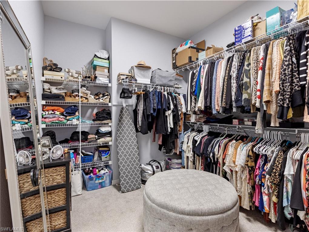 20334 Larino Loop Estero, FL 33928 - Photo 29 of 39 a view of walk in closet with clothes and shoes