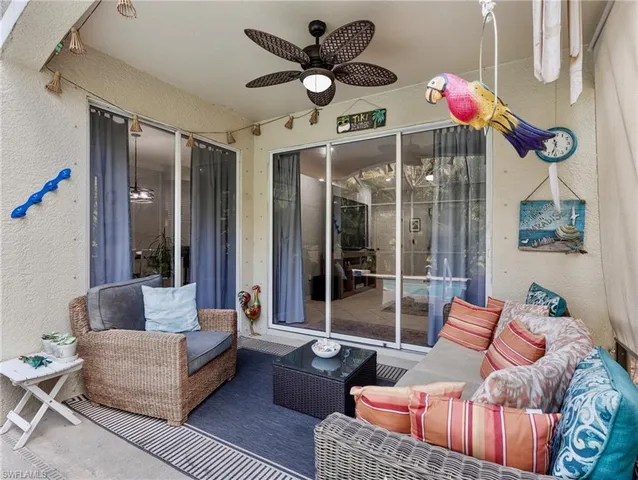 a living room with furniture a chandelier and a large window