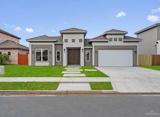 a front view of house with yard and green space
