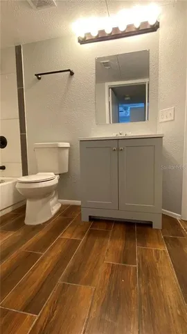 a bathroom with a toilet and a mirror