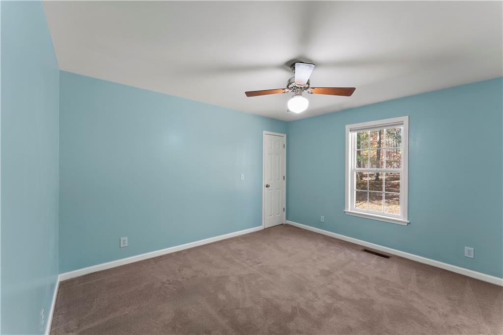 5478 Flakes Mill Road Ellenwood, GA 30294 - Photo 11 of 30 an empty room with a window and a ceiling fan