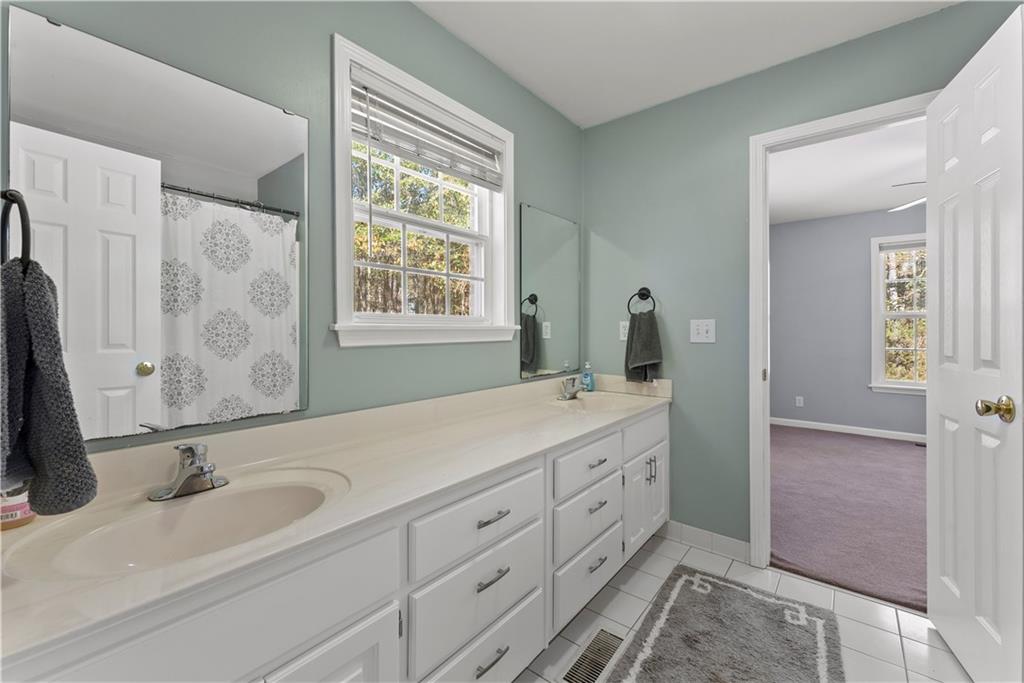 5478 Flakes Mill Road Ellenwood, GA 30294 - Photo 12 of 30 a bathroom with a double vanity sink mirror and double