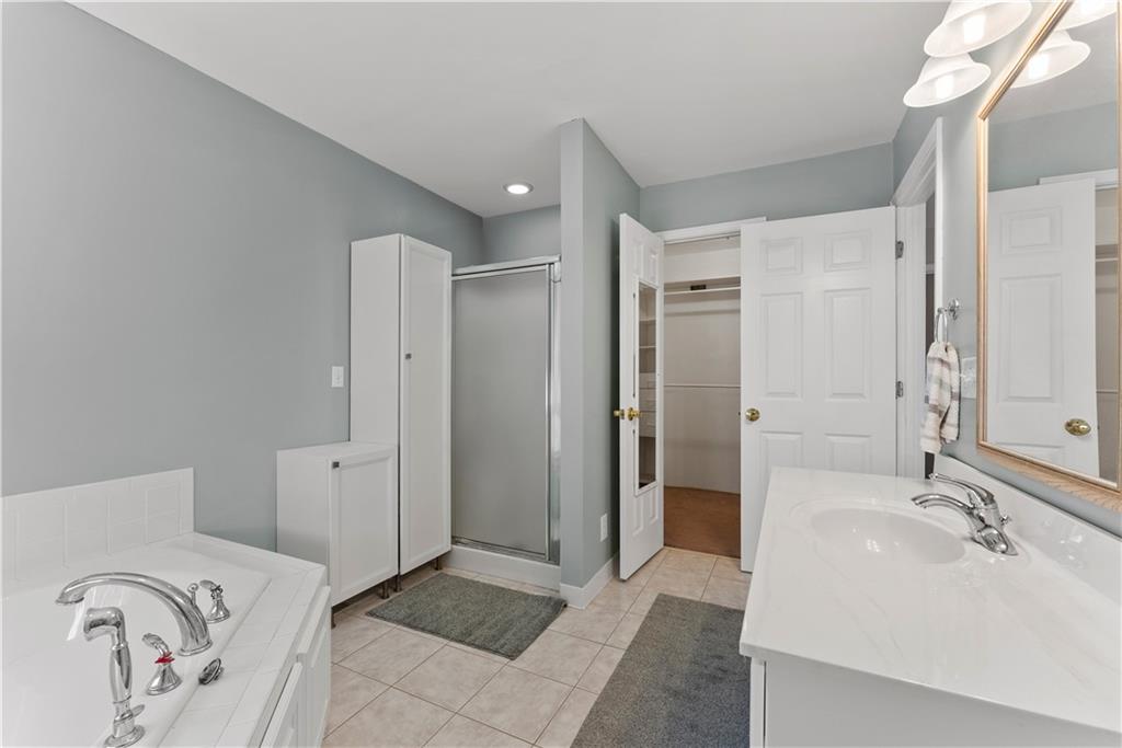 5478 Flakes Mill Road Ellenwood, GA 30294 - Photo 15 of 30 a spacious bathroom with a double vanity sink shower and a mirror