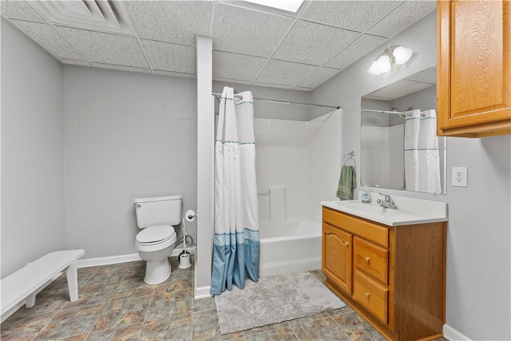 5478 Flakes Mill Road Ellenwood, GA 30294 - Photo 18 of 30 a bathroom with a sink toilet and shower
