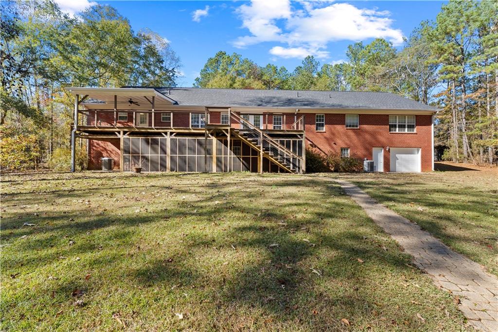 5478 Flakes Mill Road Ellenwood, GA 30294 - Photo 24 of 30 a view of a house with a yard