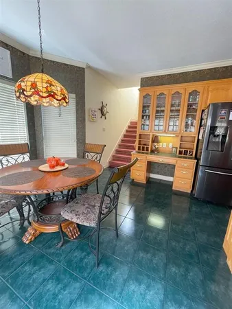 a dining room with furniture and window