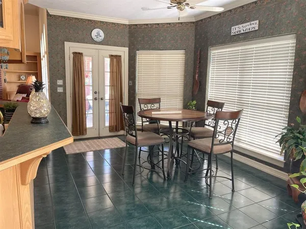 a view of a dining room with furniture and window
