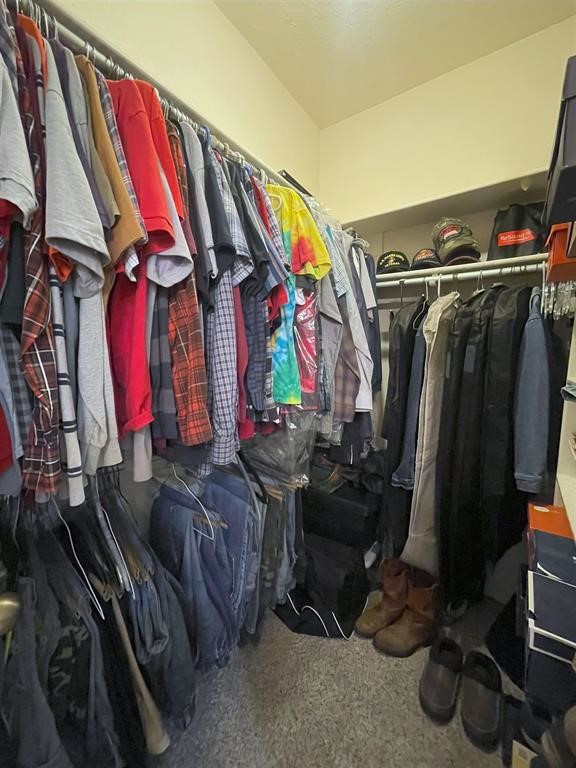 1655 Wooten Road Beaumont, TX 77707 - Photo 25 of 46 a view of walk in closet with clothes and shoes