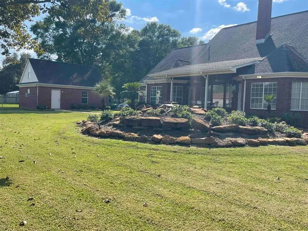 a front view of a house with garden