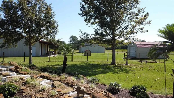 a large kitchen with stainless steel appliances granite countertop a sink and stove top oven